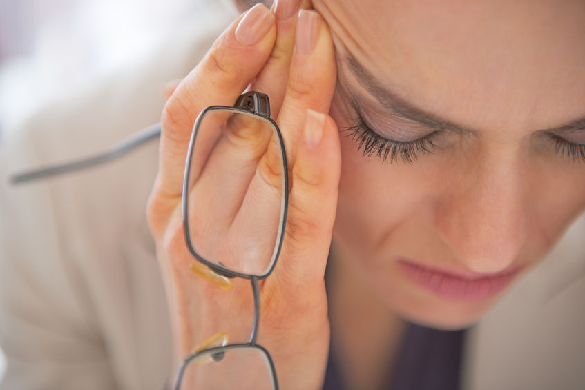 girl clutching face and glasses mental health is limiting working women