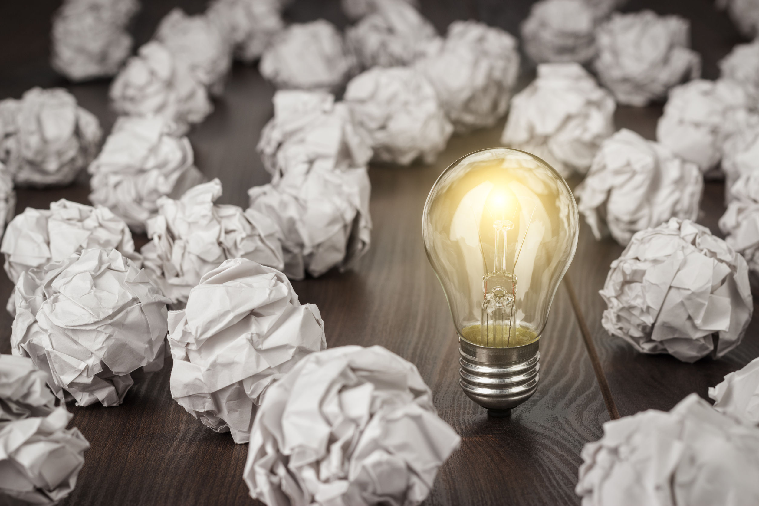 ligthed lightbulb crumpled paper in wooden desk growth mindset interventions are not effective
