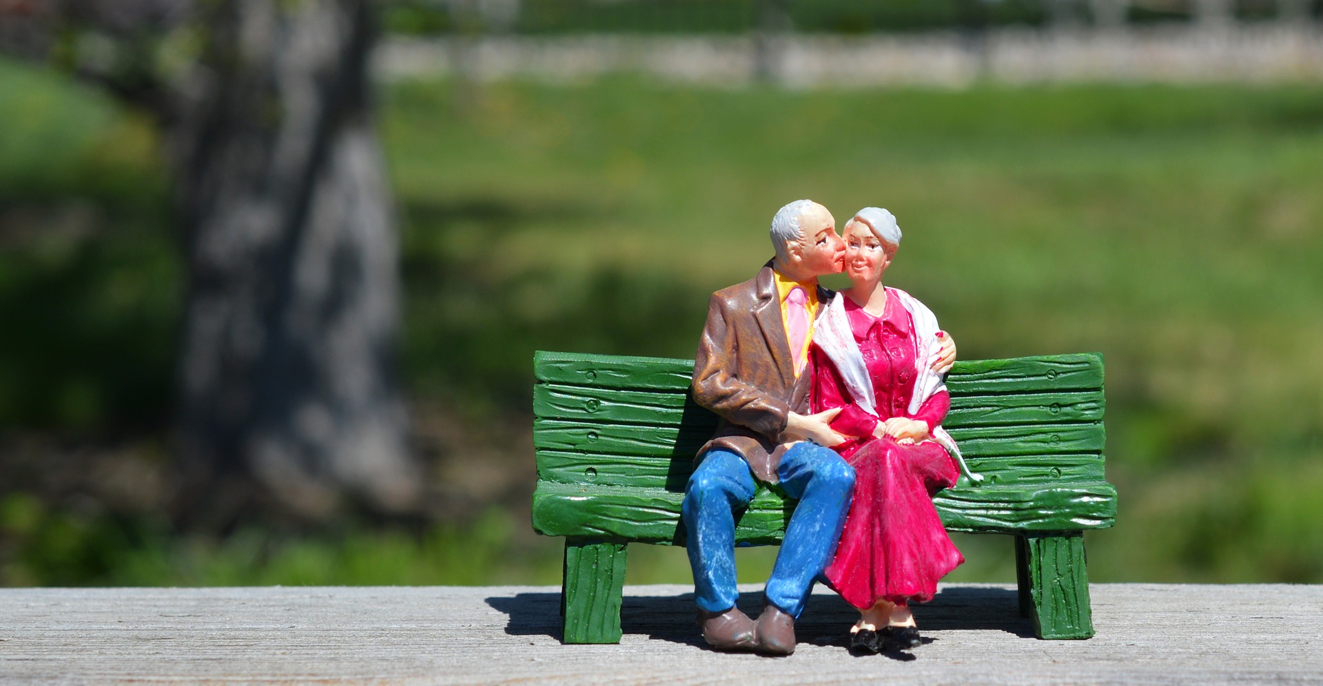 old couple in a bench figurine retirement training paradigm